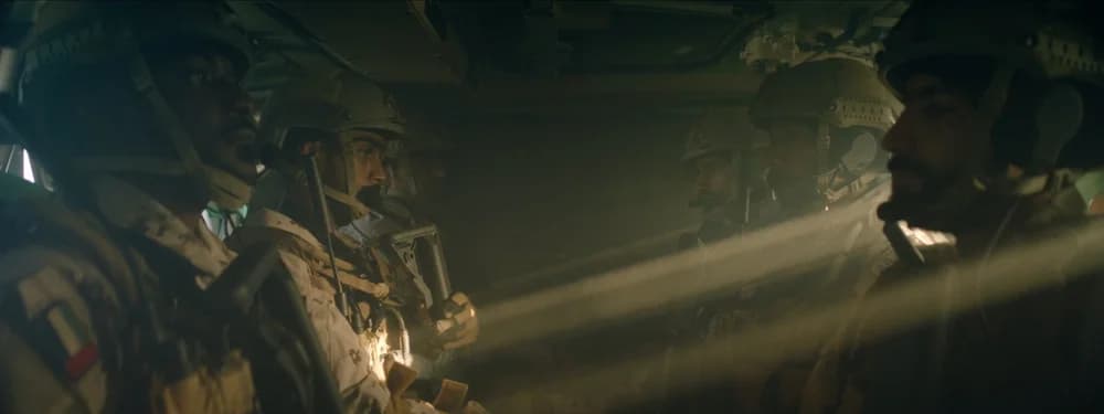Six soldiers seated inside a helicopter, cinematography by Mark Hobz